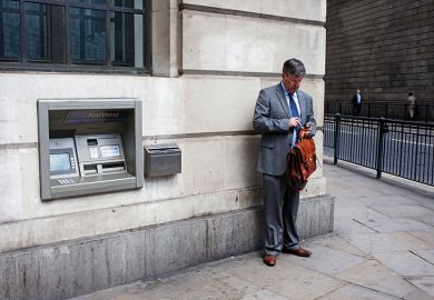 Man standing next to cash machine Man standing next to cash machine
