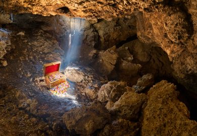 Cave with skylight streaming sunlight on a treasure chest