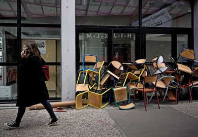 A student walks past a pile of chairs blocking a door of the Bordeaux Montaigne University, in Pessac A student walks past a pile of chairs blocking a door of the Bordeaux Montaigne University, in Pessac