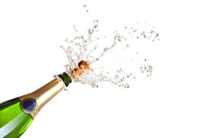 Cork popping on a champagne bottle