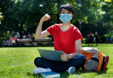 Cheering student wearing face mask