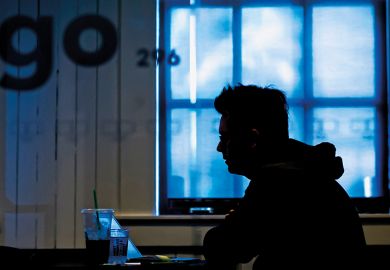 silhouette of anonymous student sitting at laptop silhouette of anonymous student sitting at laptop