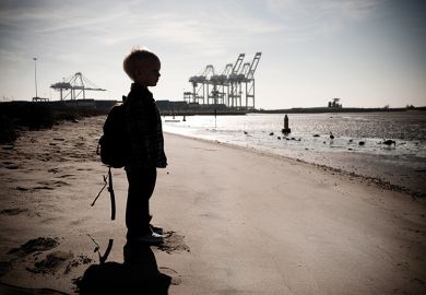 A child standing on a beach