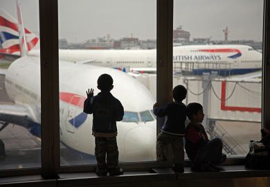 Children looking at British Airways planes out of an airport window. To illustrate the UK banning dependants.  Children looking at British Airways planes out of an airport window. To illustrate the UK banning dependants.