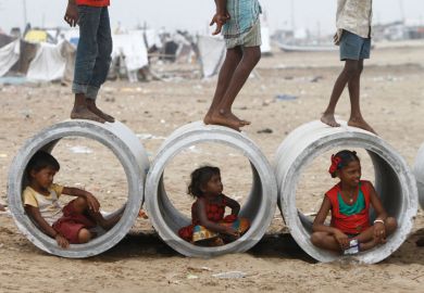 Children inside water pipes, Marina Beach, Chennai, India