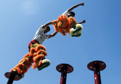 Chinese acrobatic performers jumping between poles