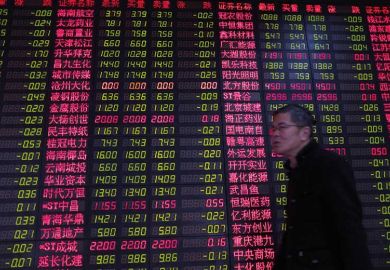 Chinese man by currency exchange board