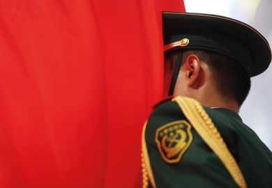 Chinese soldier with face in flag of China, Beijing, 2015
