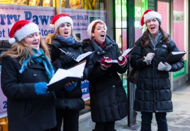 Christmas carollers in Santa hats