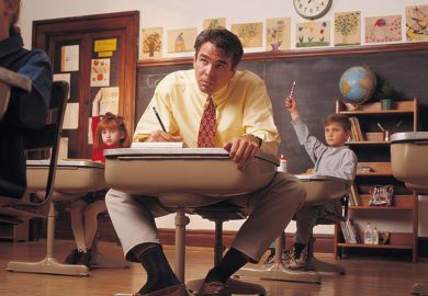 Man sits at child’s desk