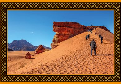 people climb the dunes in Wadi Rum desert at the top of red rock, Jordan