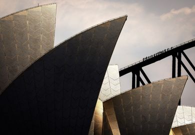People climb the Sydney Harbour Bridge behind the Sydney Opera House, illustrating the soaring costs of educating Australian university students
