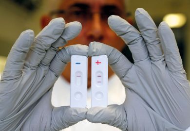 Researcher holds Ebola diagnostic tests