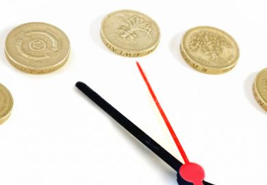 Clock hands and pound coins counting time