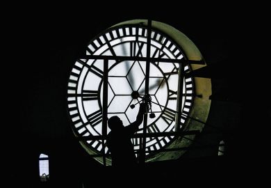 person fixing giant clock