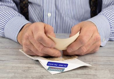 Close up view of an elderly man reading mail from an overseas relative