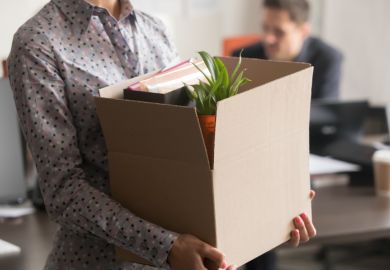 Close up view of female employee holding box, quitting job