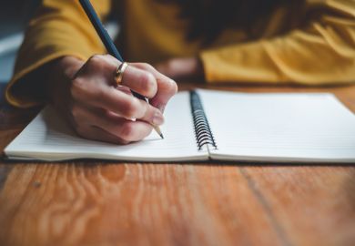 Close up woman hand writing on notebook
