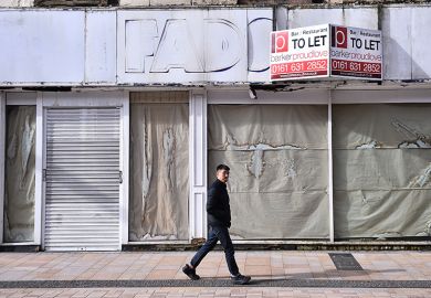 A man walks past a closed shop which is to let in Stockport, England. To illustrate that almost 4,000 courses have closed at UK universities since 2024.