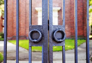 Locked gate illustrating news article about record low UK dropout rates among university students