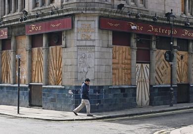Man walks past a vacant building
