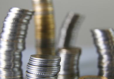 Wobbly towers of coins, symbolising unstable universities