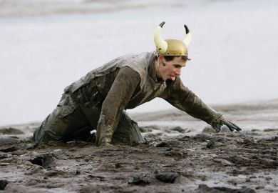 Competitor struggles during Maldon Mud Race, Essex Competitor struggles during Maldon Mud Race, Essex