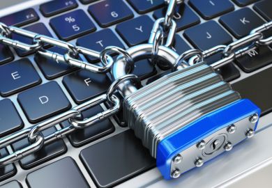 Computer keyboard locked with padlock and chain