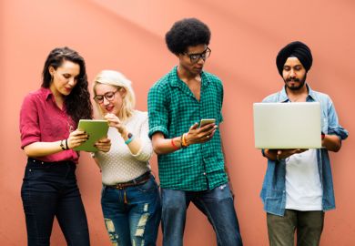 Computer science students working with mobile devices