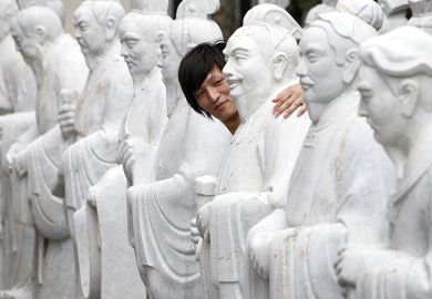  A visitor looks at the statues of Chinese sages, the 72 Disciples of Confucius, in the courtyard at the Koshi-byo, or Confucius Shrine, which also houses the Historical Museum of China, in Nagasaki, Japan