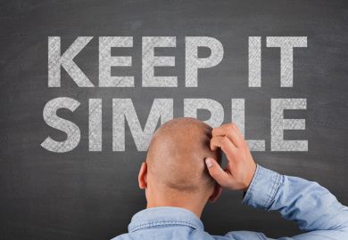 Confused man looking at 'Keep it simple' sign