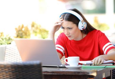 Confused student listens to online lecture