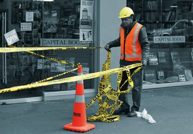 Worker putting up barrier tape