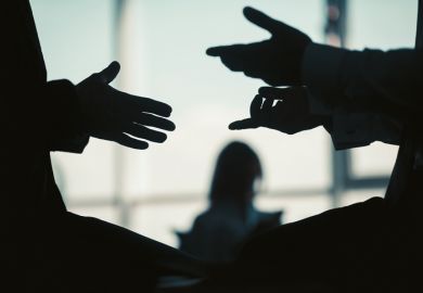 Two people in silhouette have a conversation