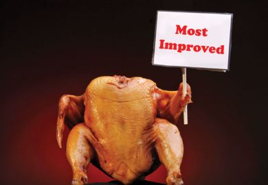 Cooked chicken holding 'Most Improved' sign Cooked chicken holding 'Most Improved' sign