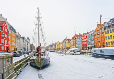 Copenhagen, Denmark - January 5, 2011 Nyhavn (New Harbor)in winter. It is waterfront, canal, entertainment district in Copenhagen in Denmark. It is lined by colorful houses, bars, cafes, wooden ships