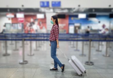 A Chinese tourist wears a surgical mask