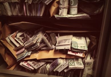 Rolls of banknotes stashed in a safe Rolls of banknotes stashed in a safe, symbolising corruption
