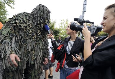 A raver is interviewed by a local TV crew during the 19th annual Techno Street Parade in Zurich A raver is interviewed by a local TV crew during the 19th annual Techno Street Parade in Zurich