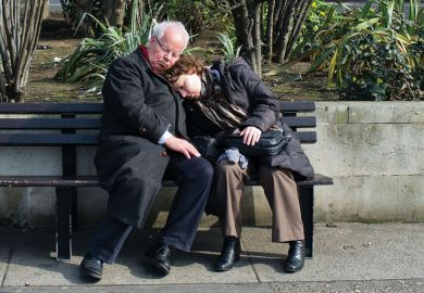 Couple sleeping on bench in London Couple sleeping on bench in London