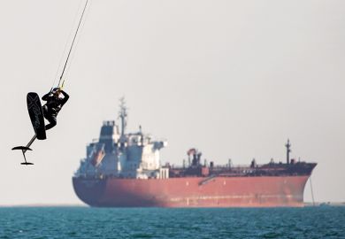 Kite surfer with tanker in the background Kite surfer with tanker in the background