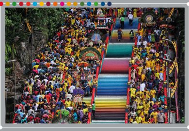 Malaysian Hindu devotees carry milk pots and kavadis as they climb steps to Sri Subramaniar Swamy Temple. To illustrate Malaysian universities climbing towards the top of the Impact Rankings 2025.