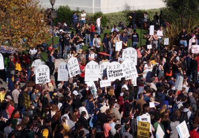 Crowd of protesters hold signs and rally tuition increases in front of Sproul Hall on UC Berkeley November 18 2009