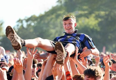  A music fan wearing a crown crowd surfs at the TRNSMT Festival. To illustrate academic communities in all parts of the UK helping rising stars of humanities and social sciences to shine.