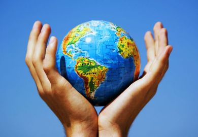 Cupped hands holding globe aloft