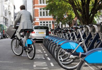 Man in suit rides Boris bike (Santander cycle) in London Man in suit rides Boris bike (Santander cycle) in London