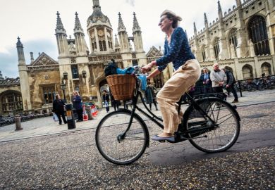 Cyclist outside University of Cambridge