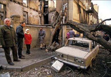 Destructions around the Parliament, with a Lada car damaged by a fallen tree,, Tbilisi, Georgia, 1992. As an illustration for whether massification has driven UK higher education to the end of the road.