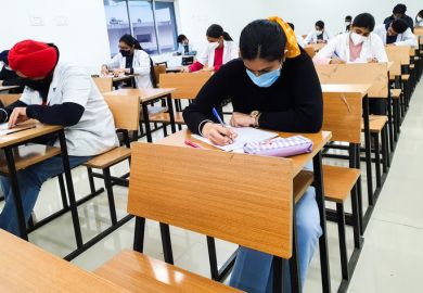 December 8, 2020.Lucknow Uttar Pradesh,India. West Bengal India. Medical students writing examination paper in mask maintaining social distancing at Radheshwam Medical College,Lucknow, UP, India.
