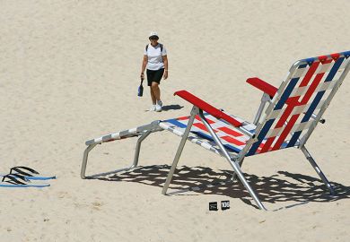 Woman walks near an oversized deckchair artwork ’Recliner Rex’ by New Zealand artist Regan Gentry on Tamarama Beach in Sydney, 2005